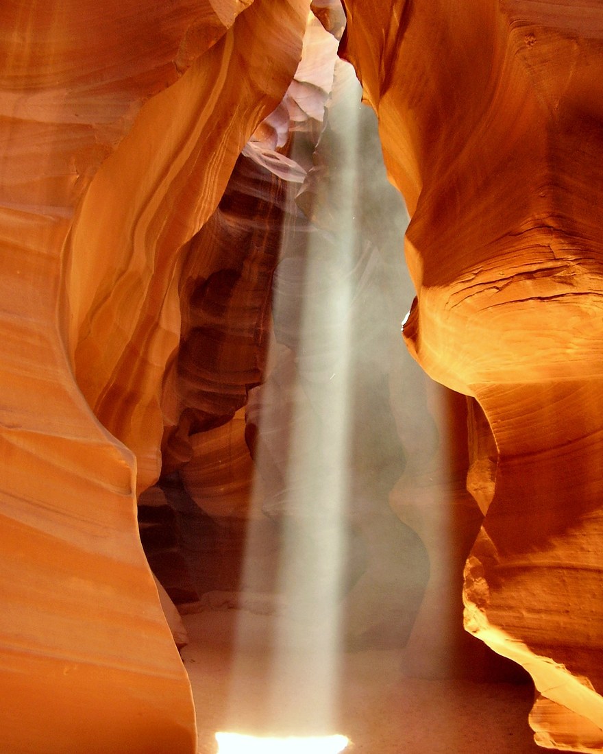 Sunbeam shining through the swirling sandstone walls of Antelope Canyon